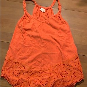 Burnt orange tank with eyelet detail at the bottom
